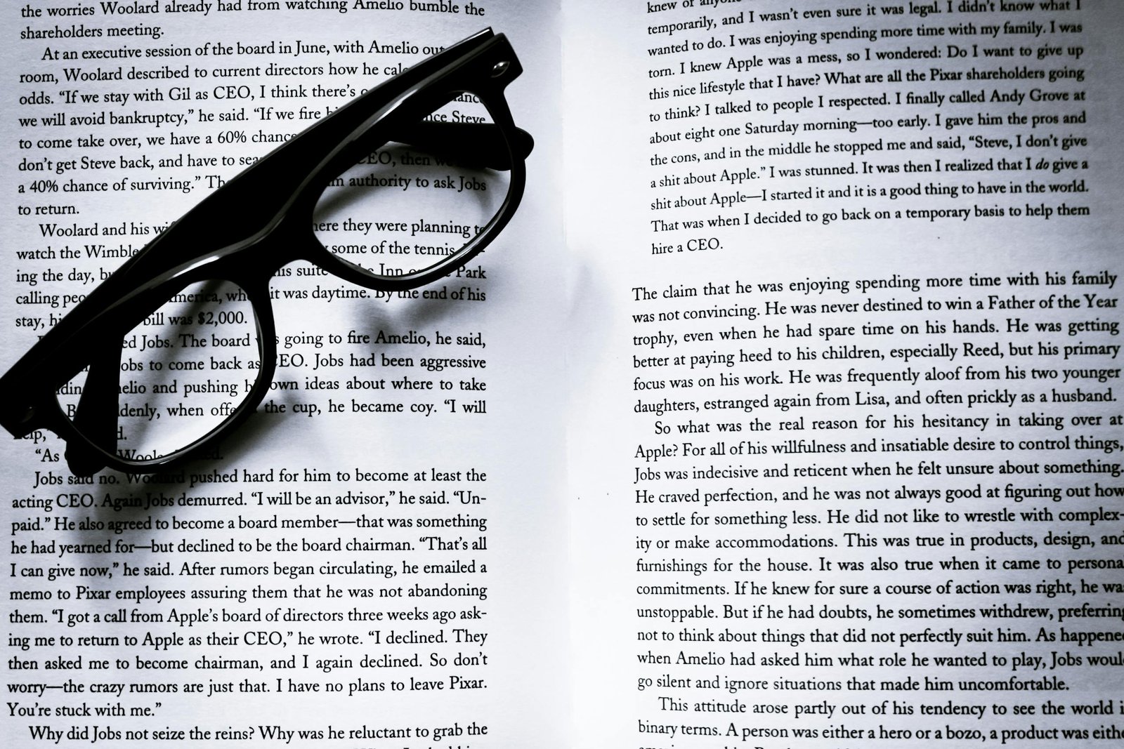 Black eyeglasses on open book pages with visible text, ideal for study themes.